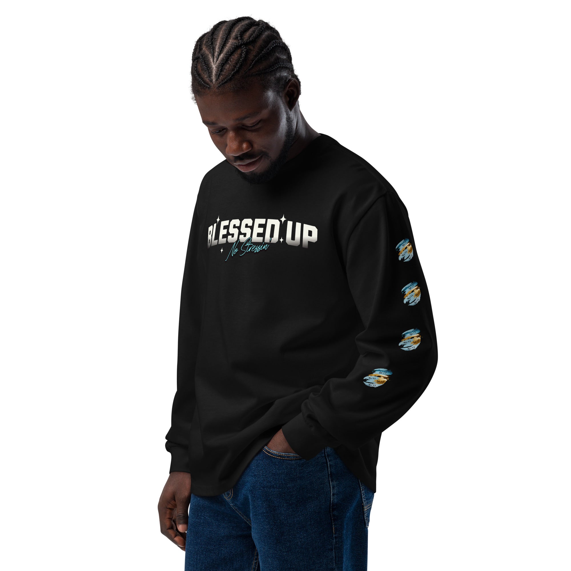 Man wearing premium black heavyweight sweatshirt with text design saying Blessed Up No Stressin" across front chest area, also with intricate bible verse design on left and right sleeve